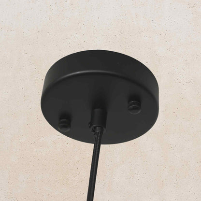 Black ceiling light fixture on a beige wall