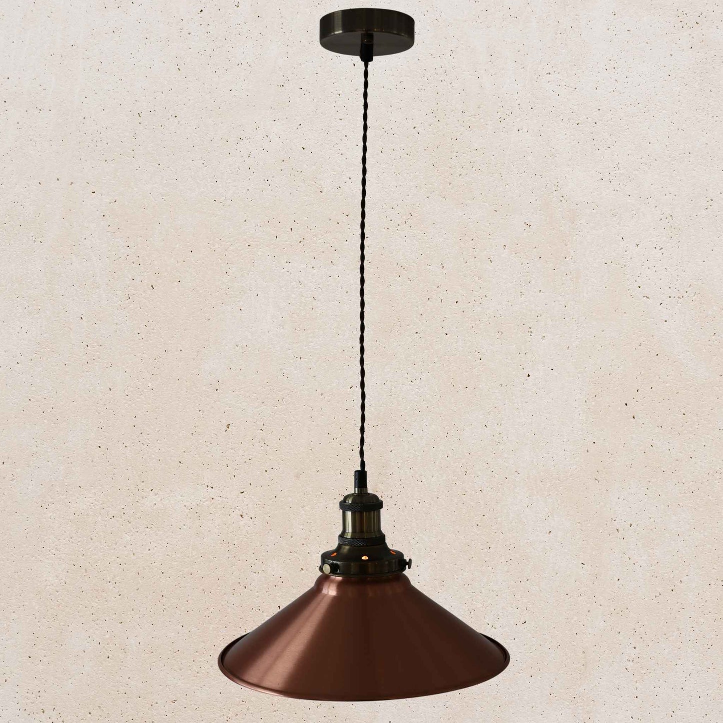 Copper pendant light against a beige textured wall