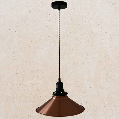 Copper pendant light with black fixture on a beige background