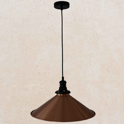 Copper pendant light against a beige wall