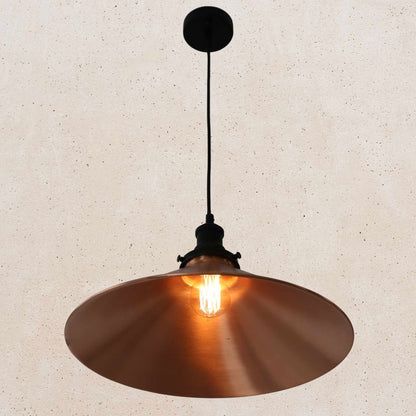Copper pendant light against a beige wall