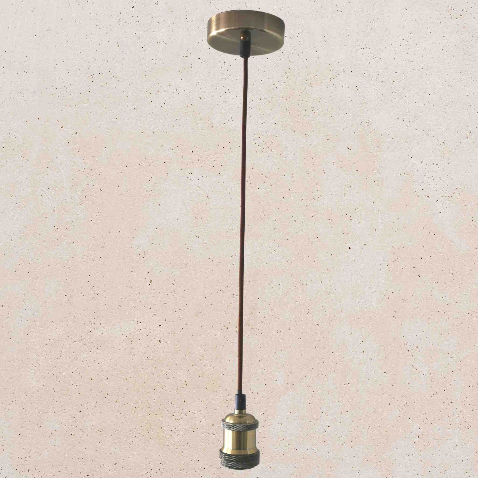 Bronze pendant light fixture on a beige speckled background