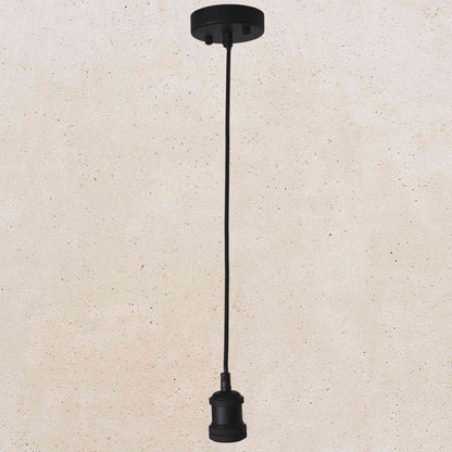 Black pendant light fixture on a beige background