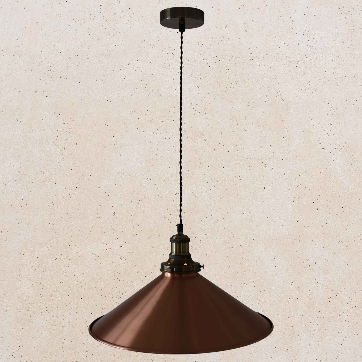 Copper pendant light against a beige wall