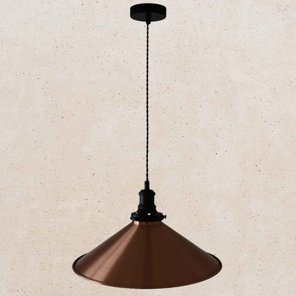 Copper pendant light against a beige wall