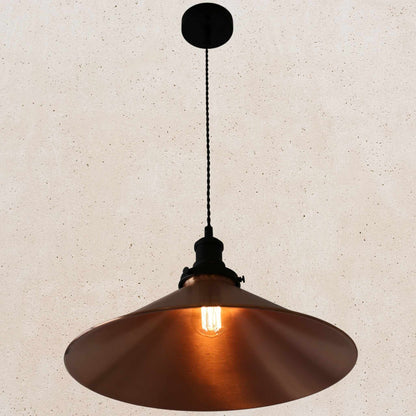 Copper pendant light against a beige wall