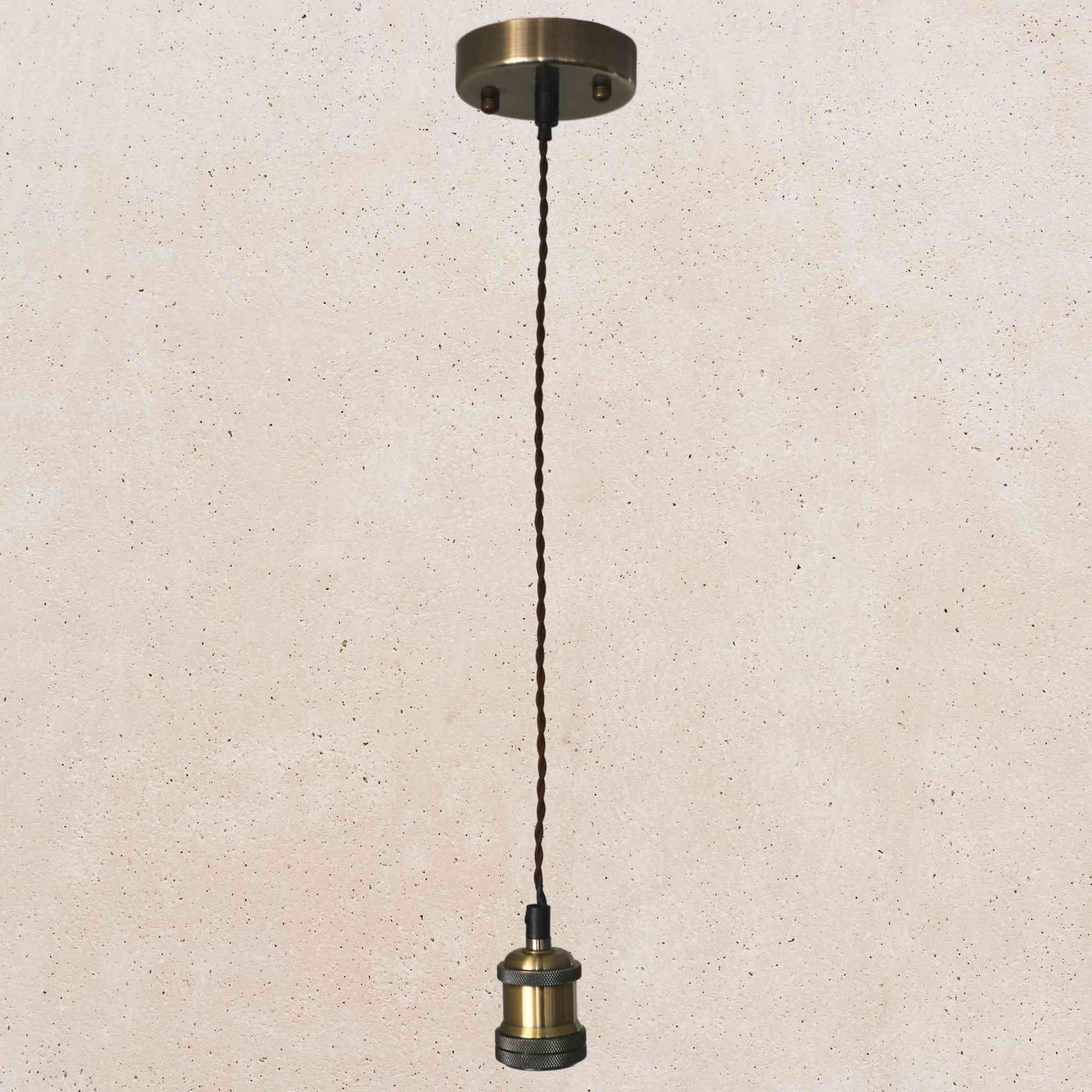 Bronze pendant light fixture on a beige speckled background