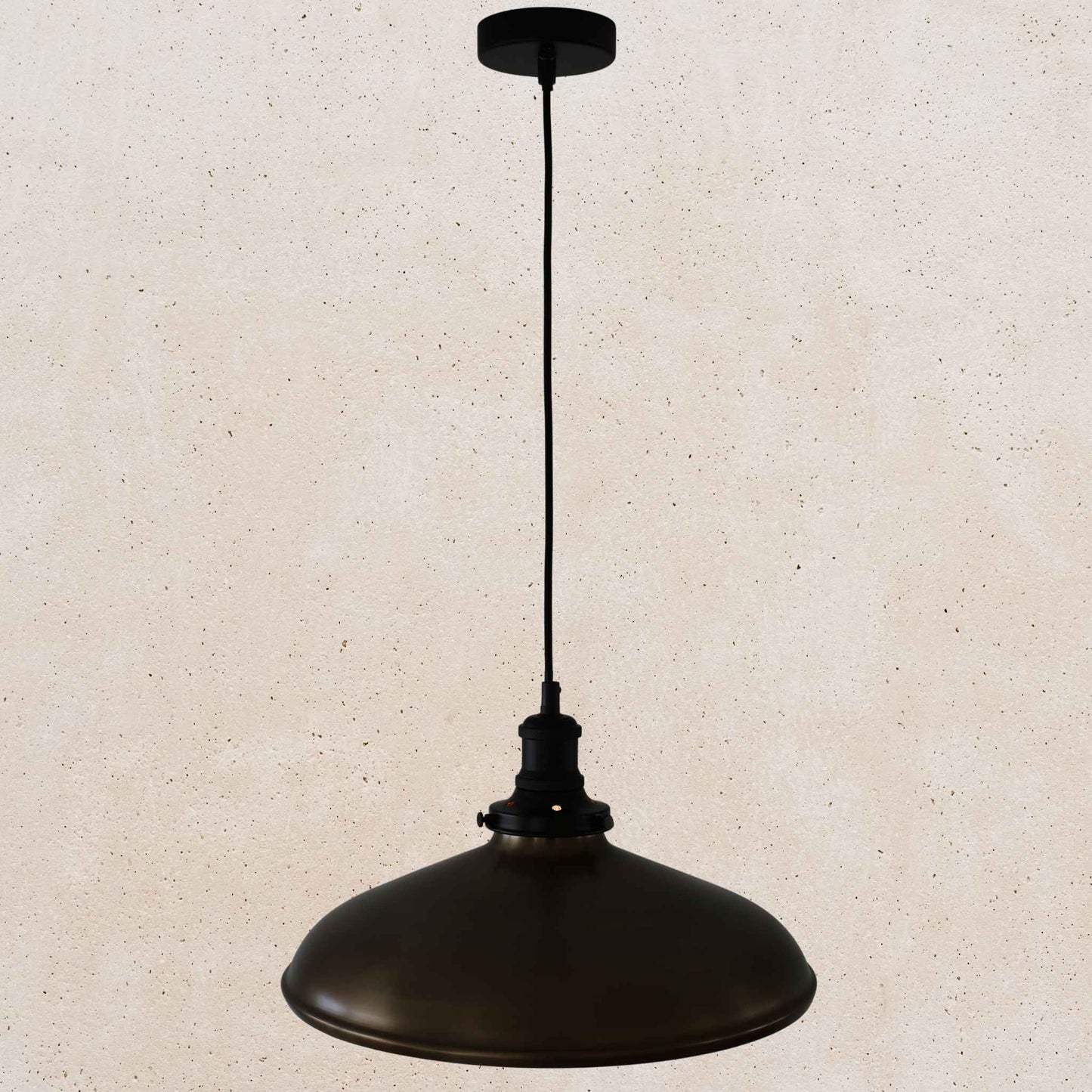 Antique brass pendant light on a beige speckled background