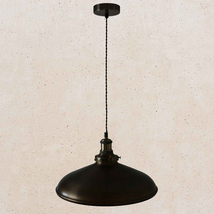 Antique brass pendant light on a beige speckled background