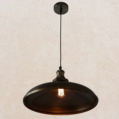 Antique brass pendant light on a beige speckled background