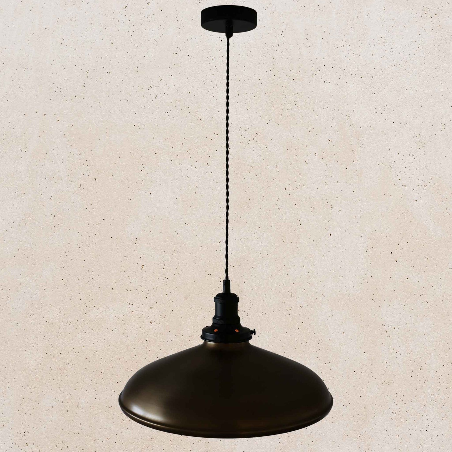 Antique brass pendant light on a beige speckled background