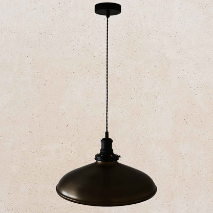 Antique brass pendant light on a beige speckled background