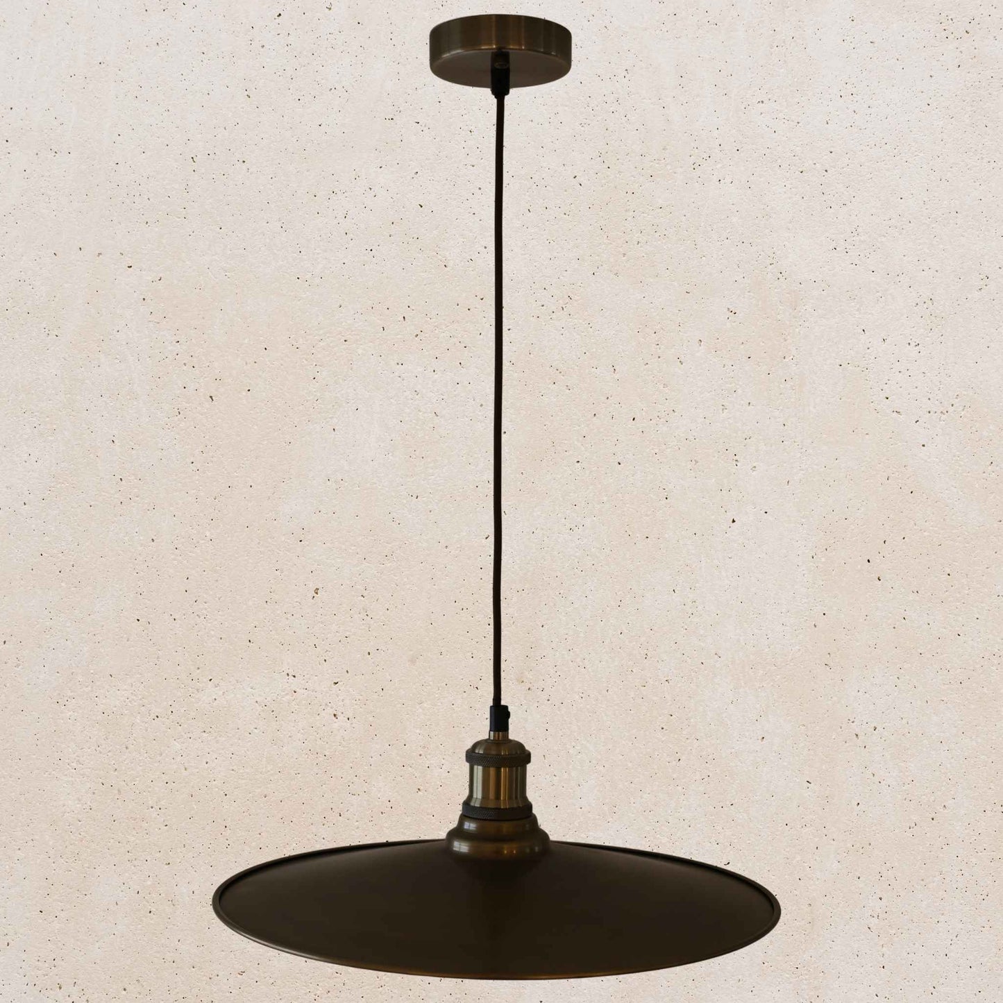 Antique brass pendant light fixture on a beige background