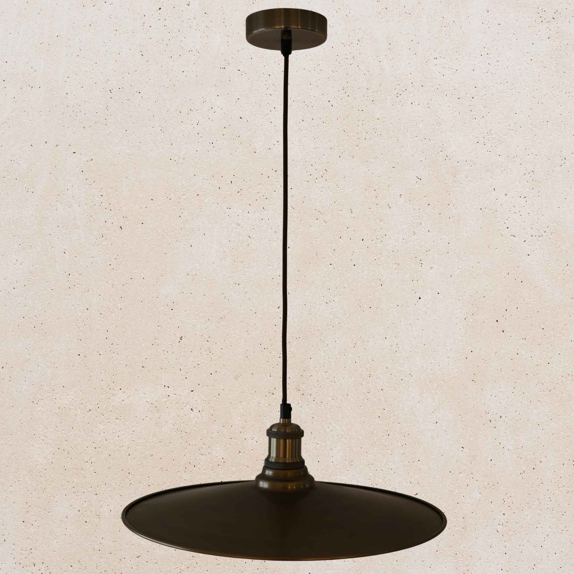 Antique brass pendant light fixture on a beige background