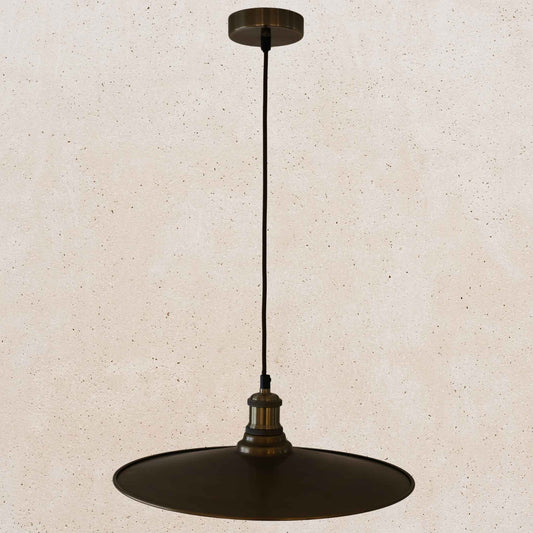 Antique brass pendant light fixture on a beige background