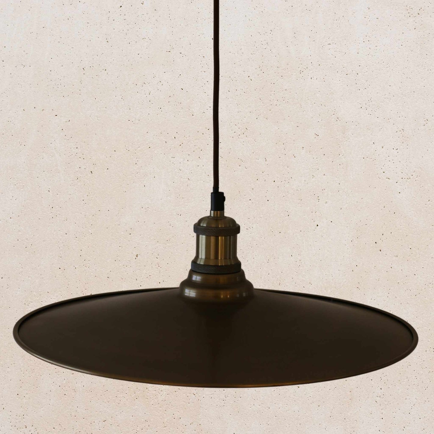 Antique brass pendant light fixture on a beige background