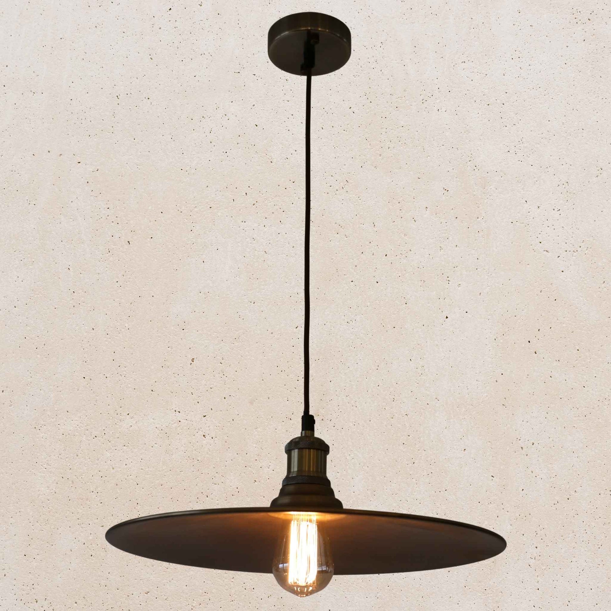 Antique brass pendant light fixture on a beige background