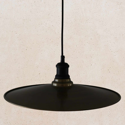 Antique brass pendant light fixture on a beige background