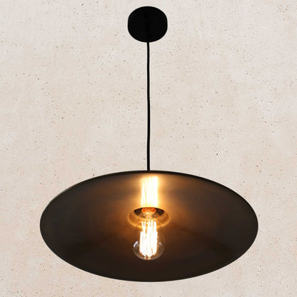 Antique brass pendant light fixture on a beige background