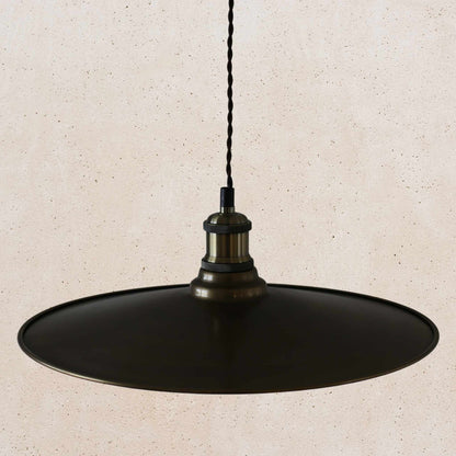 Antique brass pendant light fixture on a beige background