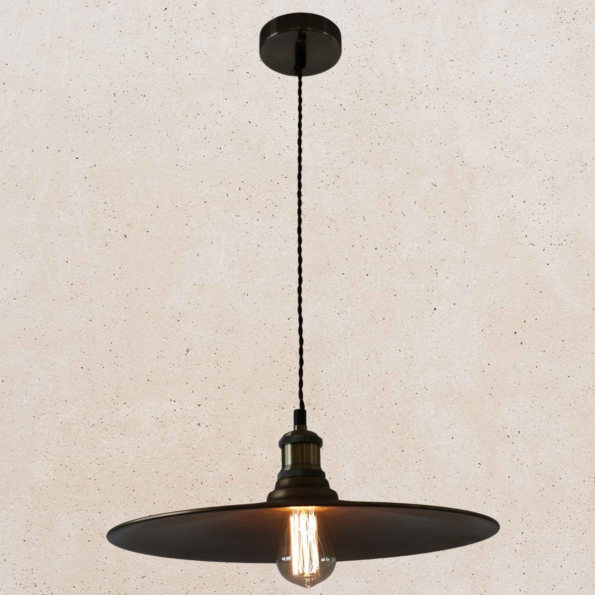 Antique brass pendant light fixture on a beige background