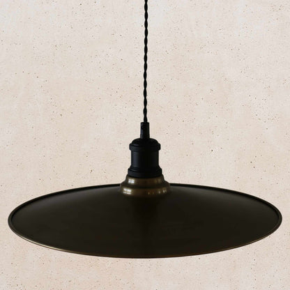 Antique brass pendant light fixture on a beige background