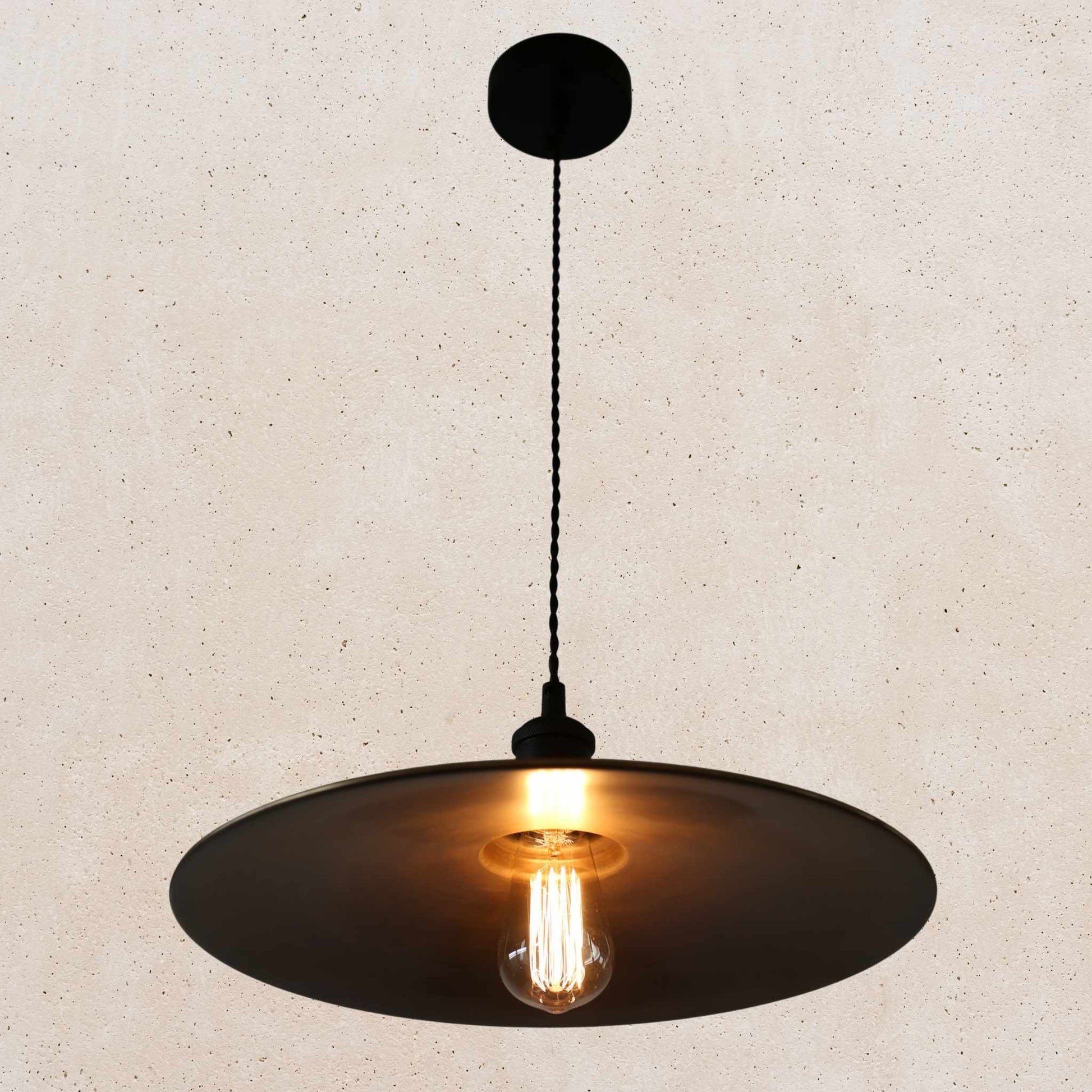 Antique brass pendant light fixture on a beige background