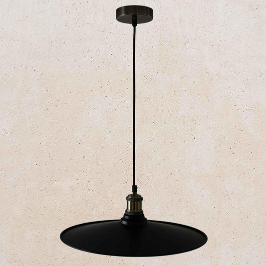 Black pendant light on a beige background