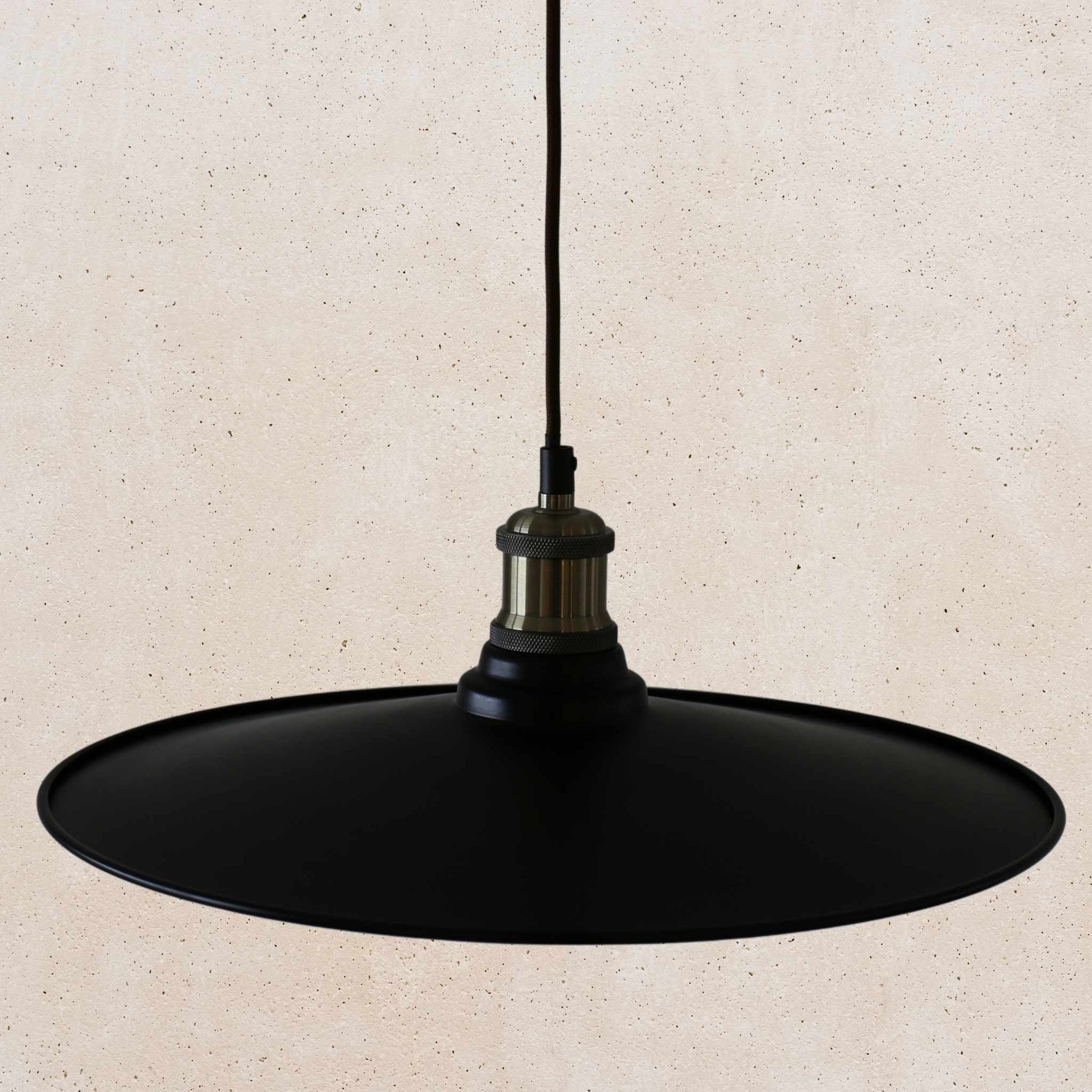 Black pendant light on a beige background