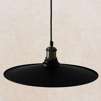 Black pendant light on a beige background