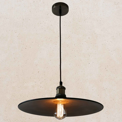 Black pendant light with a lit bulb on a beige background