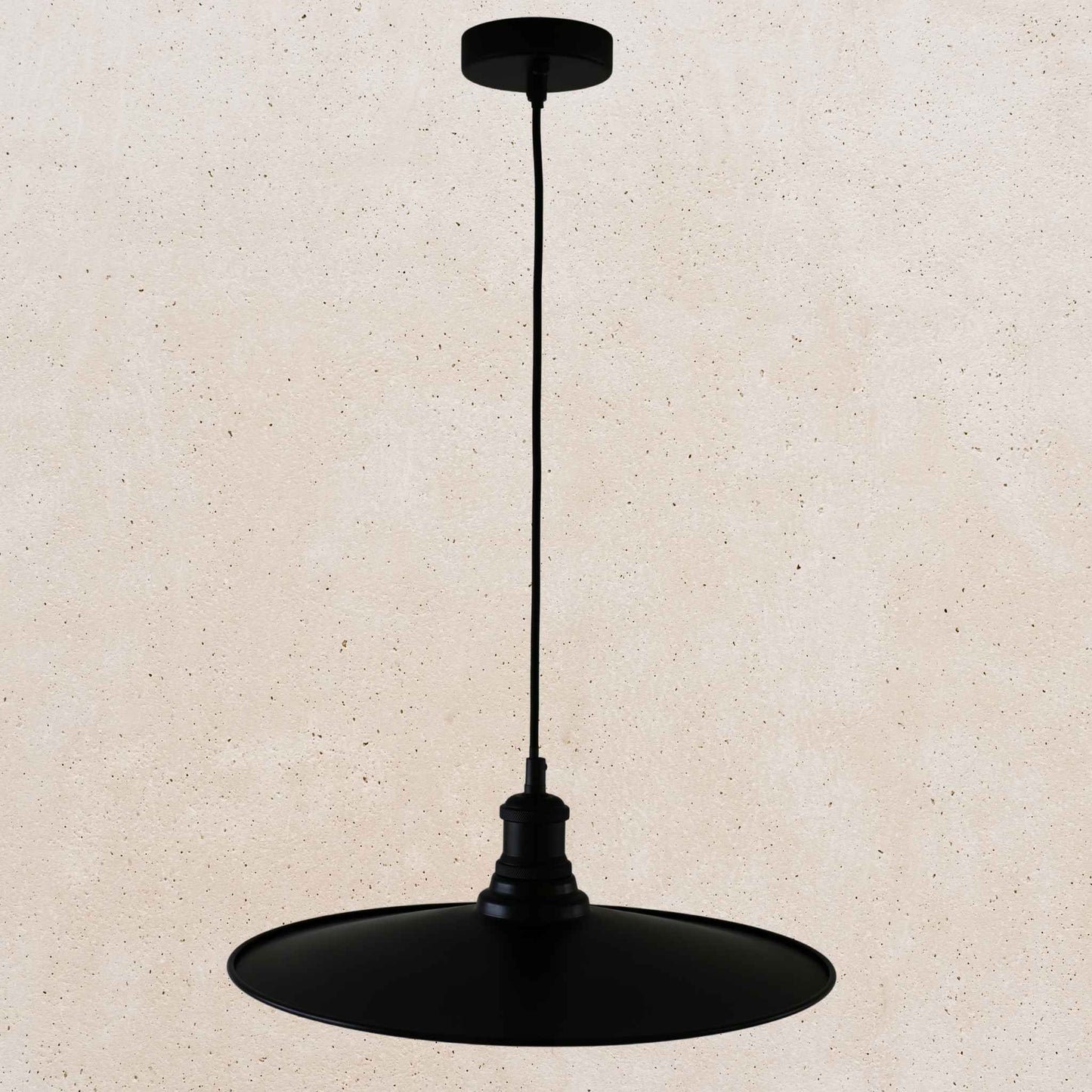 Black pendant light on a beige background