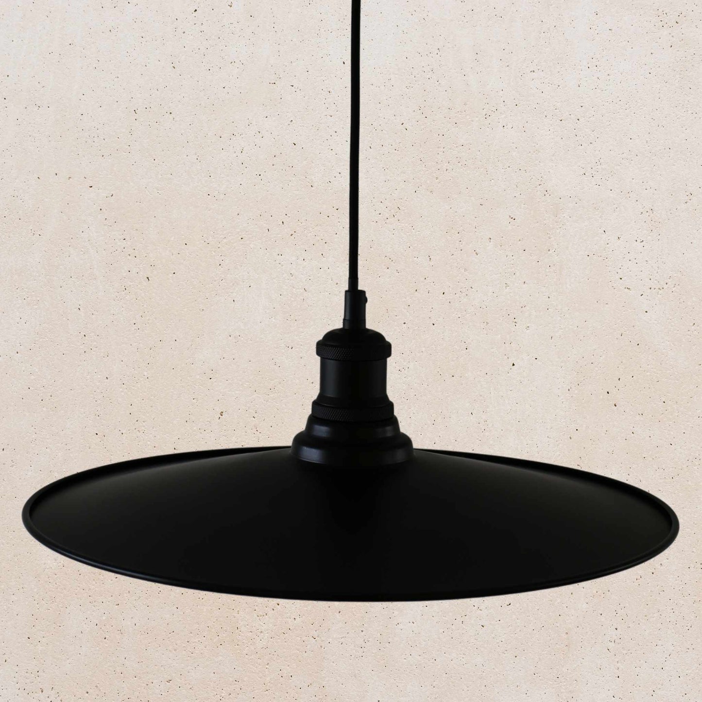 Black pendant light on a beige background
