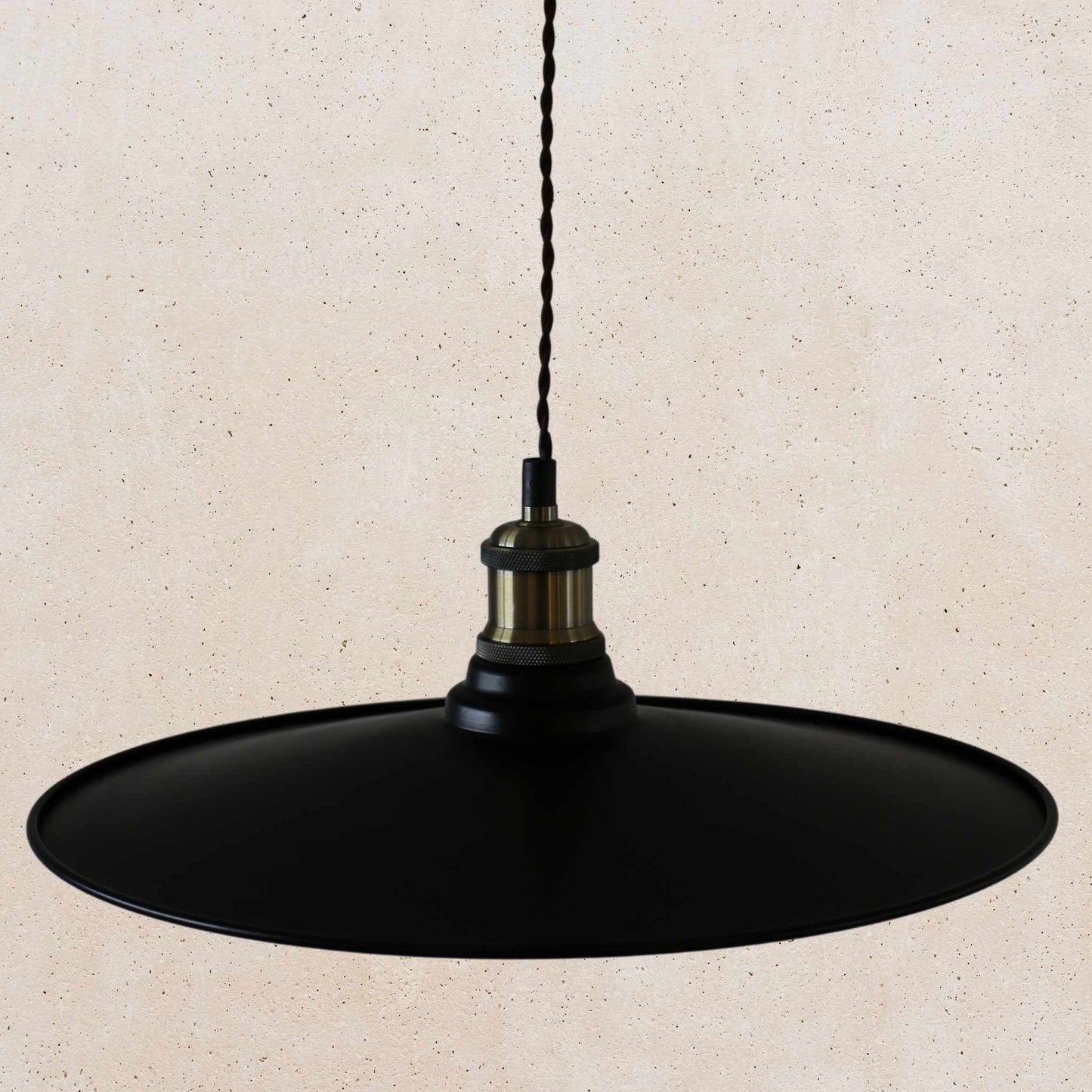 Black pendant light on a beige background