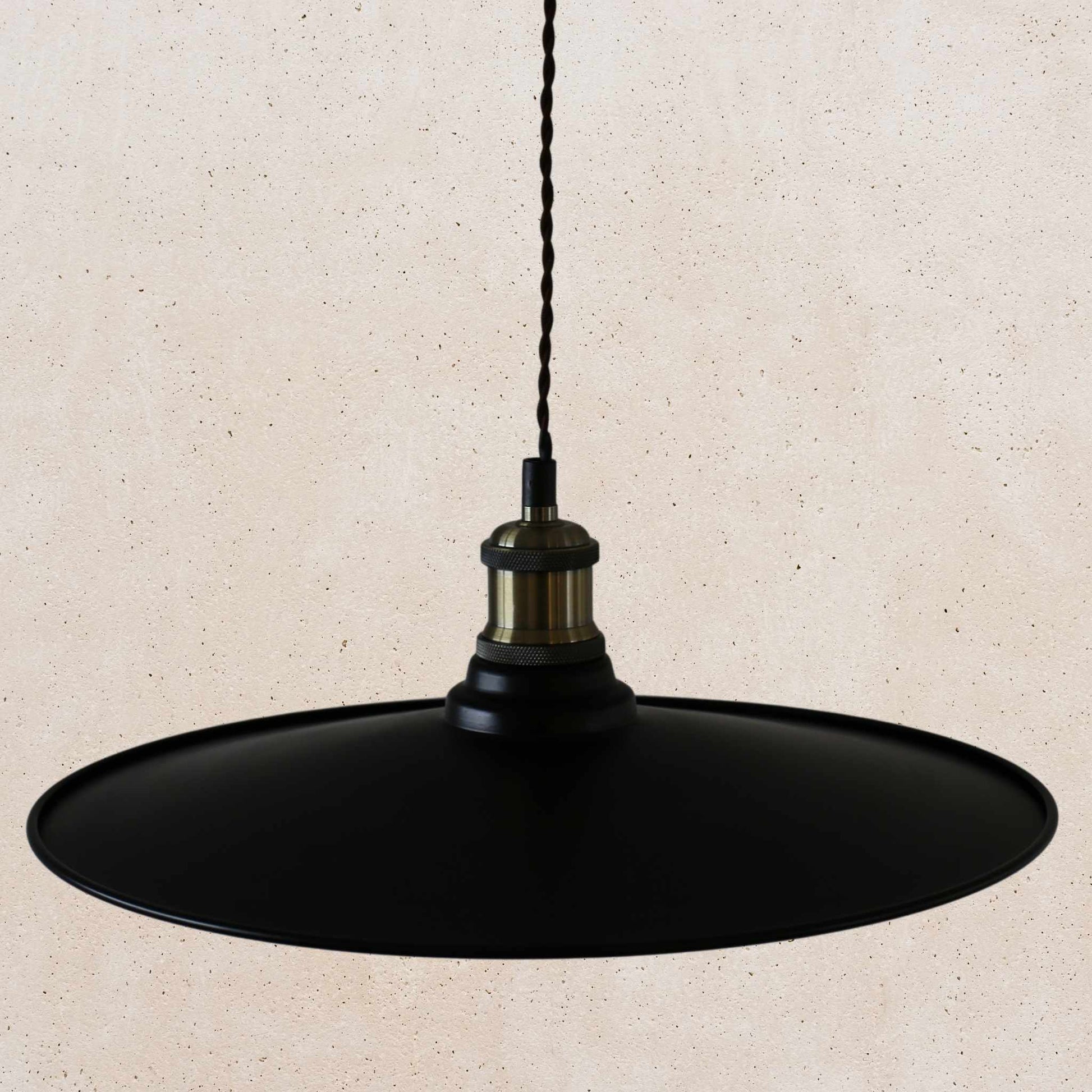 Black pendant light on a beige background