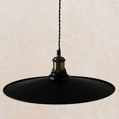 Black pendant light on a beige background