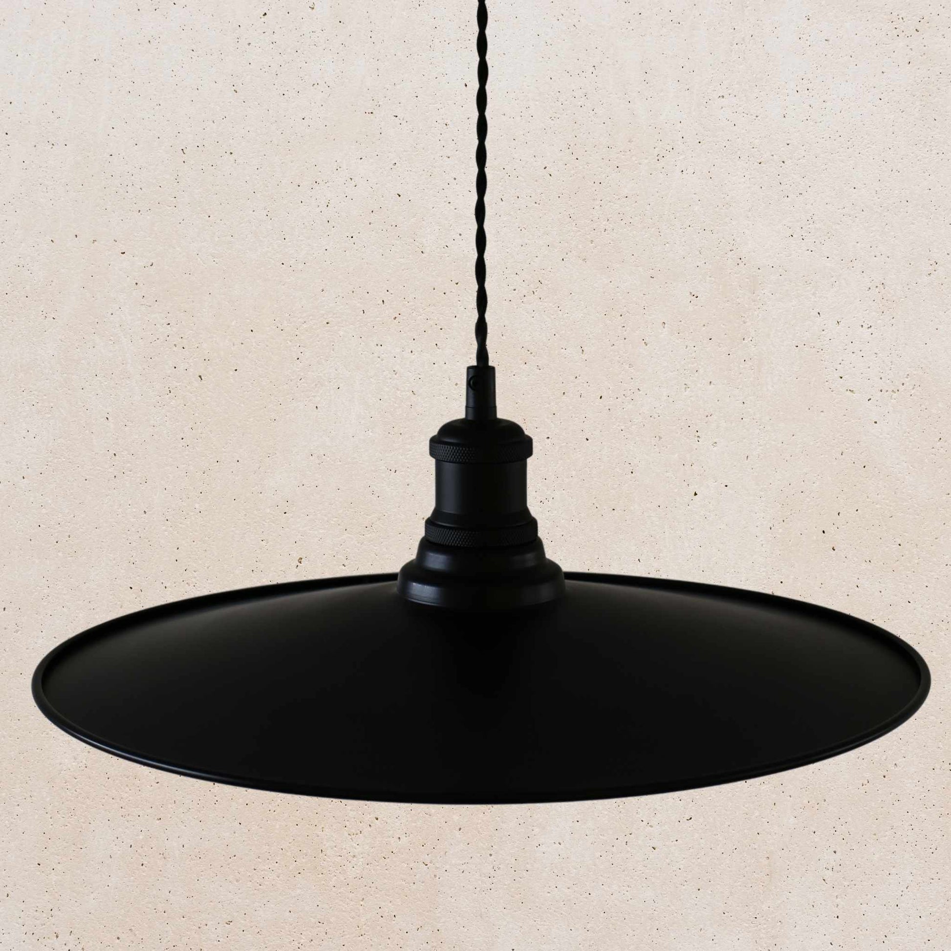 Black pendant light on a beige background